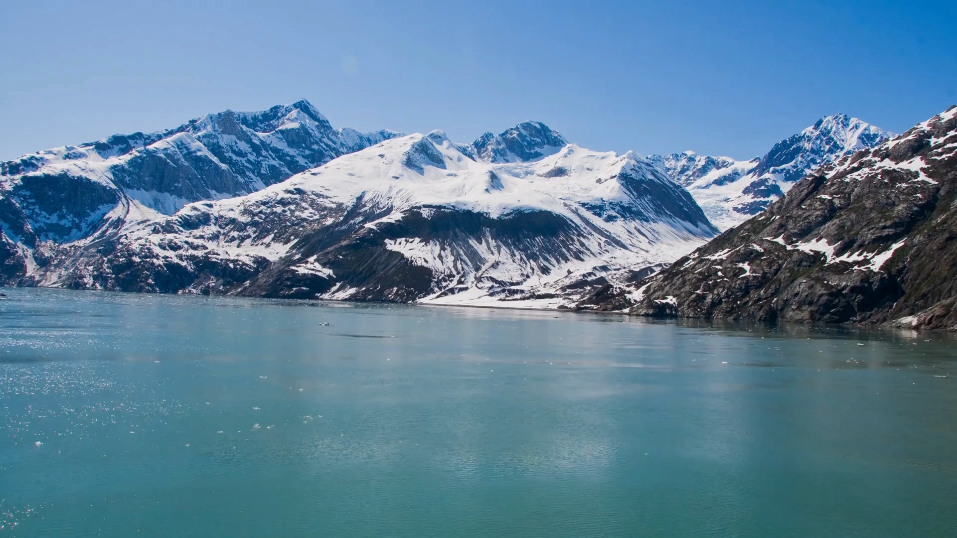 Glacier Bay National Park features breathtaking glaciers and tranquil waters, framed by towering mountains and vibrant nature.